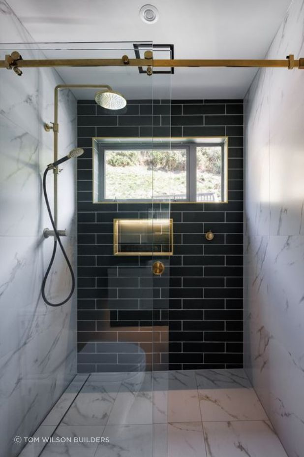 The collaboration of metal fixtures and cool-toned colours brings the home's modern and Victorian mixed aesthetic to the bathroom