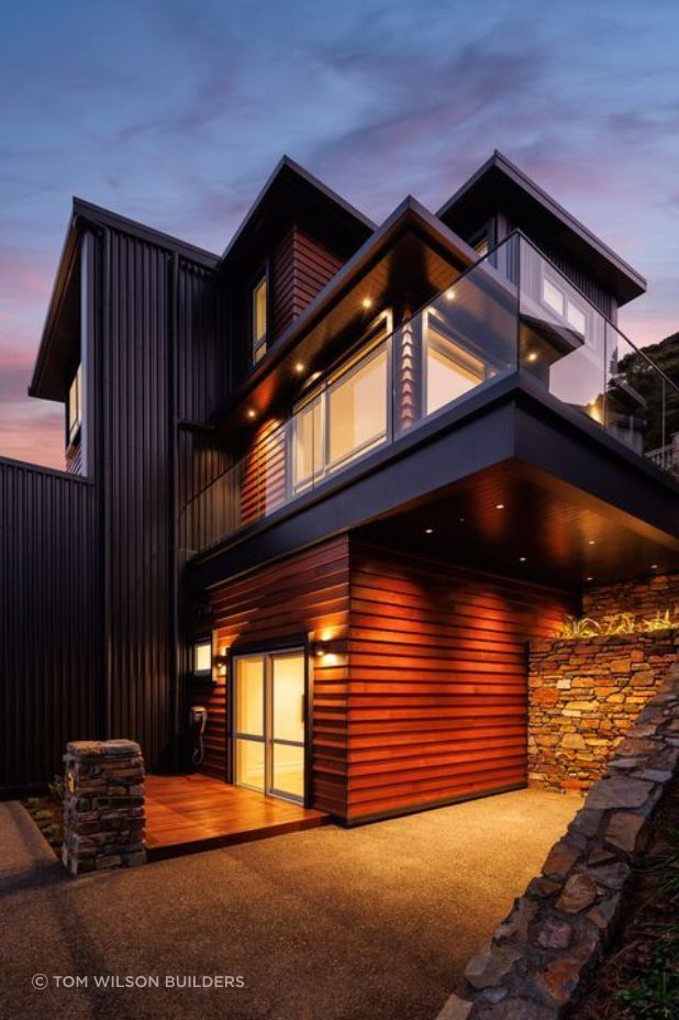 The home's exterior lighting evokes a sense of warmth and elegance