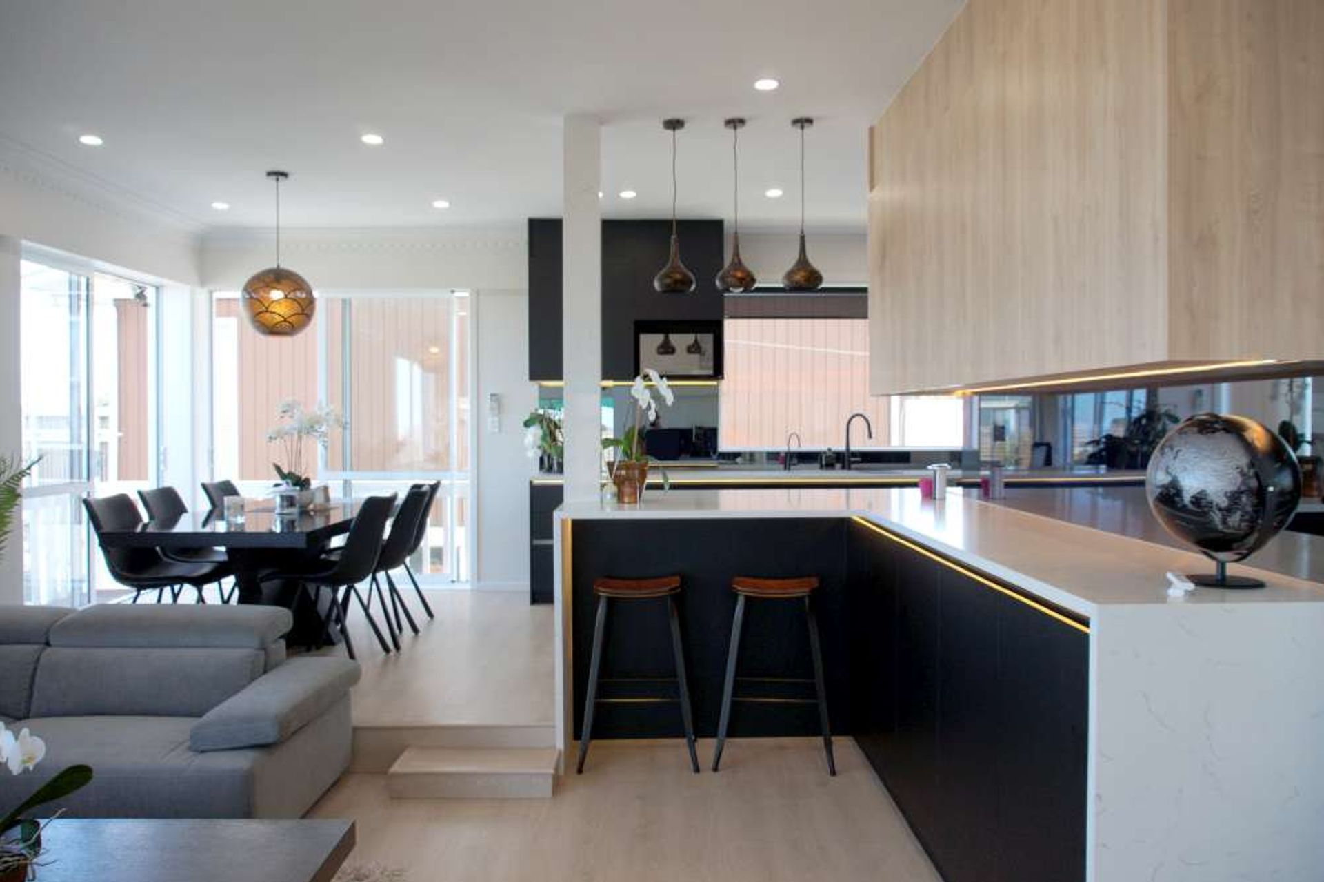 AFTER we demolished the wall we were able to create a large kitchen with a entertainer’s bar extending to the living room