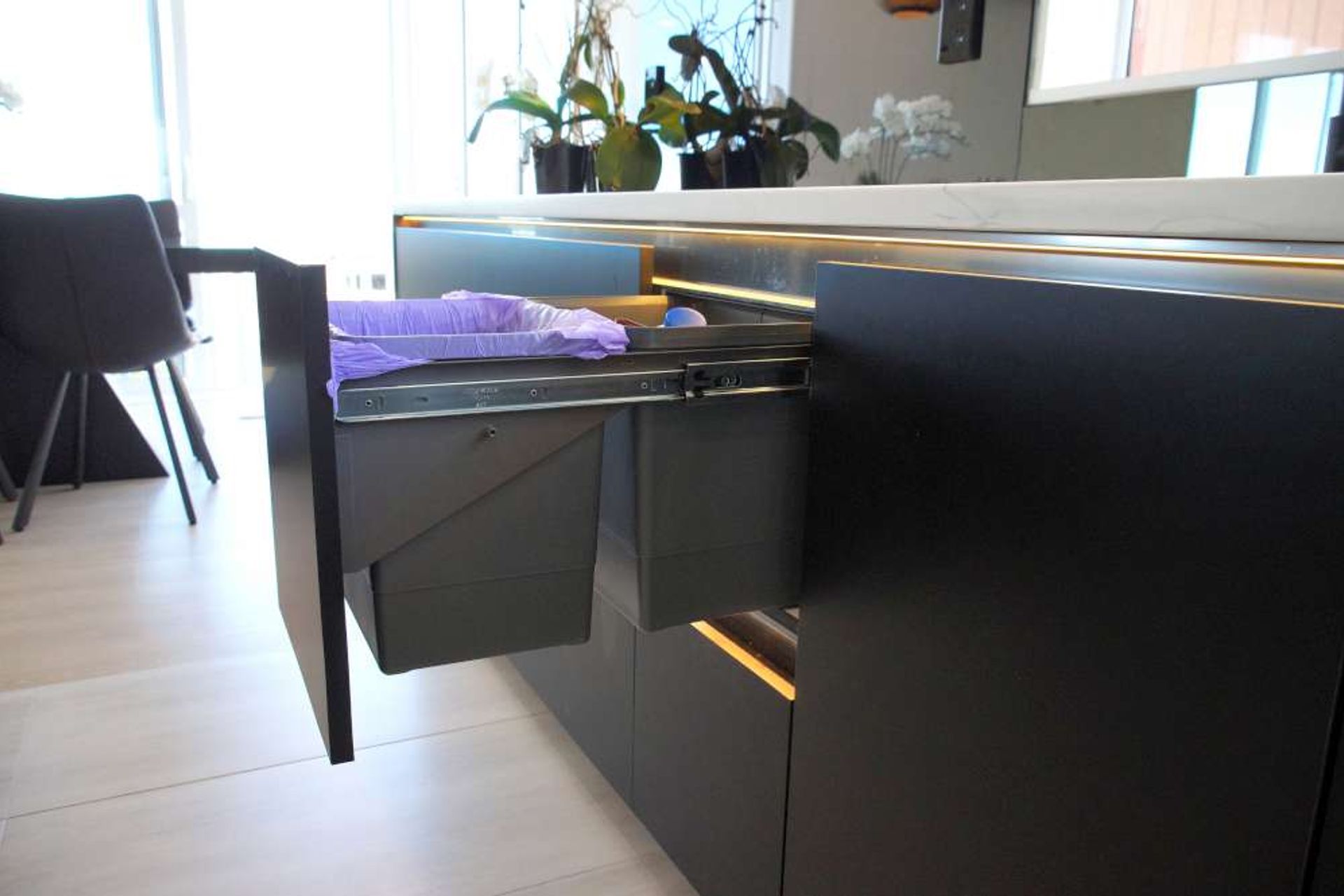 Pull out rubbish and recycling bins.