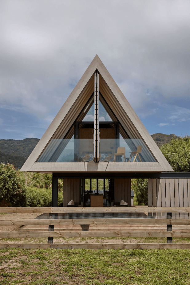 A view of the front of the house, with the master bedroom and protected balcony on the first floor, and the outdoor living space tucked underneath.