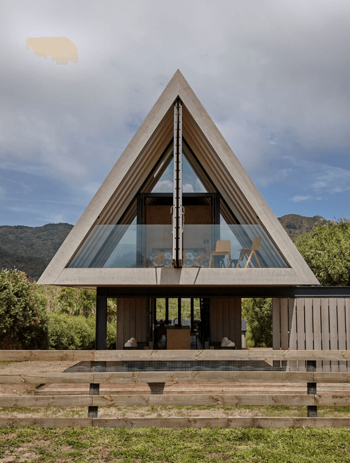 A view of the front of the house, with the master bedroom and protected balcony on the first floor, and the outdoor living space tucked underneath.