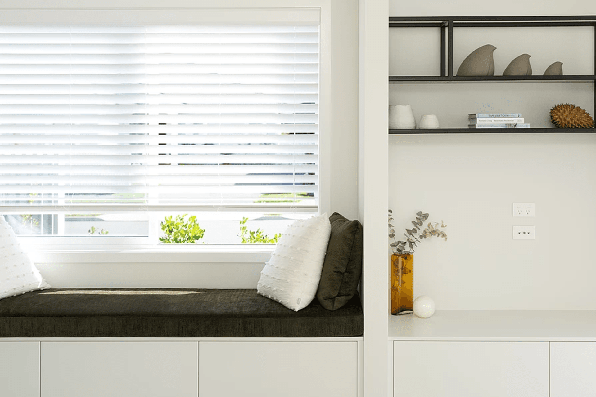 In this streamlined design the TV is hidden behind a sliding door. The clients did not want the TV to be a focal point in the room, but at the same time wanted it positioned in a practical location.