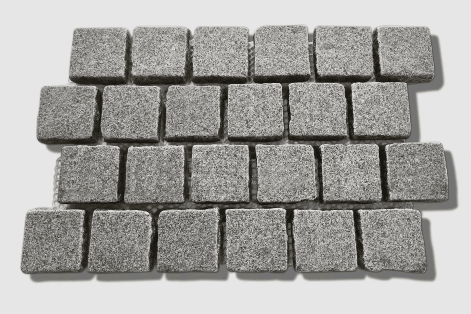 Silhouette Granite Tumbled Cobblestones launched in 2025. Dense mid-grey granite with P5 slip resistance, mounted on mesh sheets in brick bond pattern. The 90×90×30mm format is ideal for driveways, pathways, courtyards, and high-traffic outdoor areas.