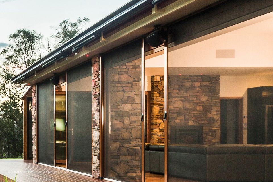 Caption: A Securo side roll blind operates just like a sliding door for ease of access. Here it is shown in Phiferglass insect screen fabric.