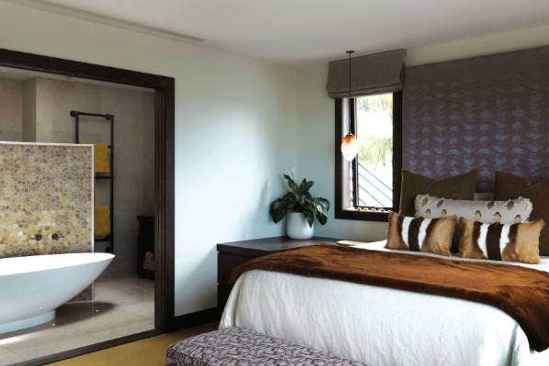 Stone is a feature inside and out and much of it, like this screen in the en suite, is supplied by Island Stone in Tauranga; the pillows are mementoes from travel in Africa.