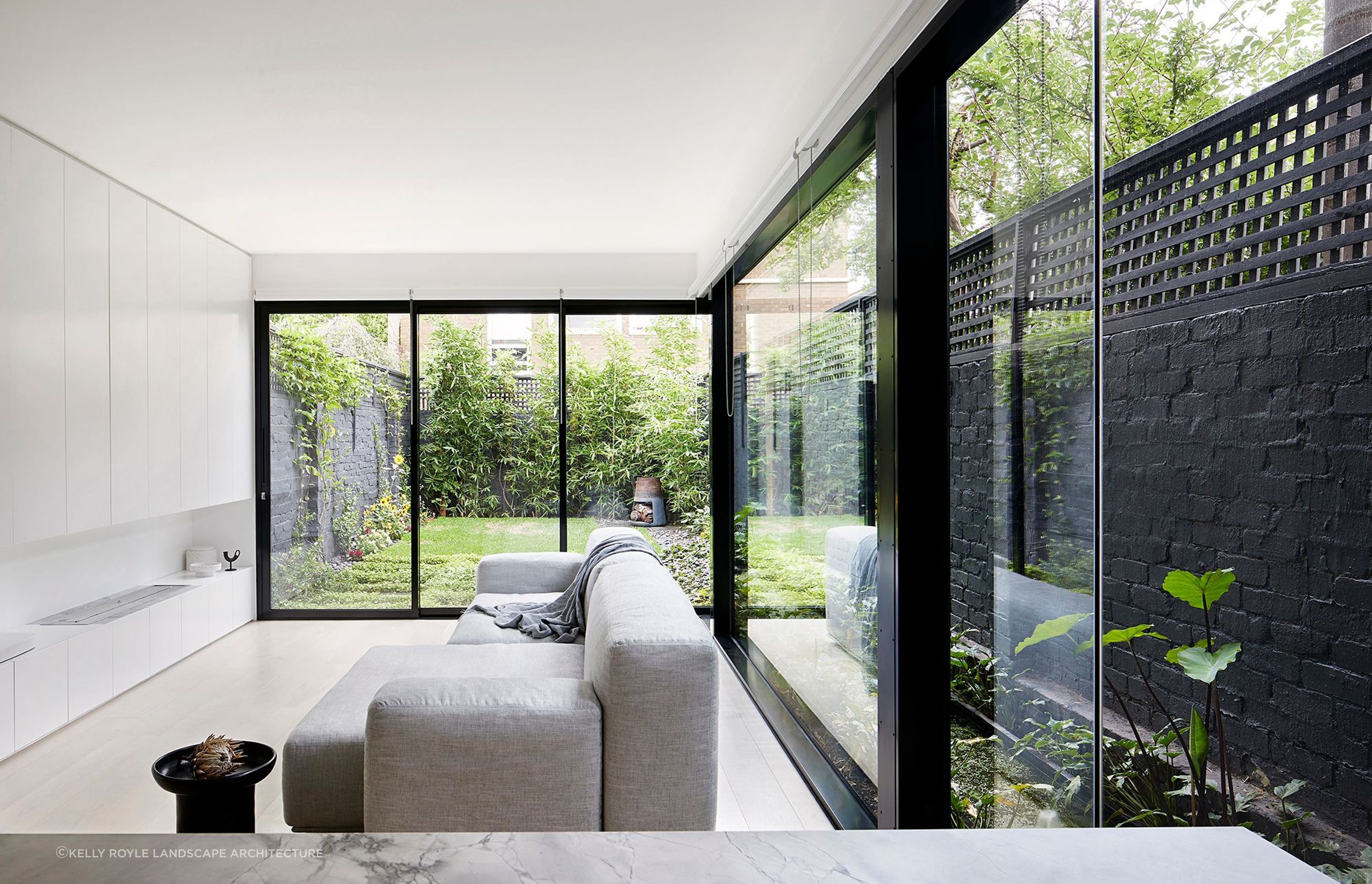 Large windows and natural light accentuate the open space that extends into the garden in this contemporary home in South Yarra - Photography: Tatjana Plitt