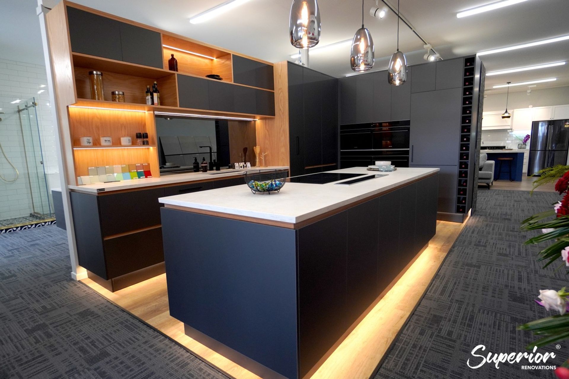 Our renovation showroom in Wairau Valley, Auckland. This is a great example of a modern and sleek kitchen which has storage on both sides of the kitchen island.
