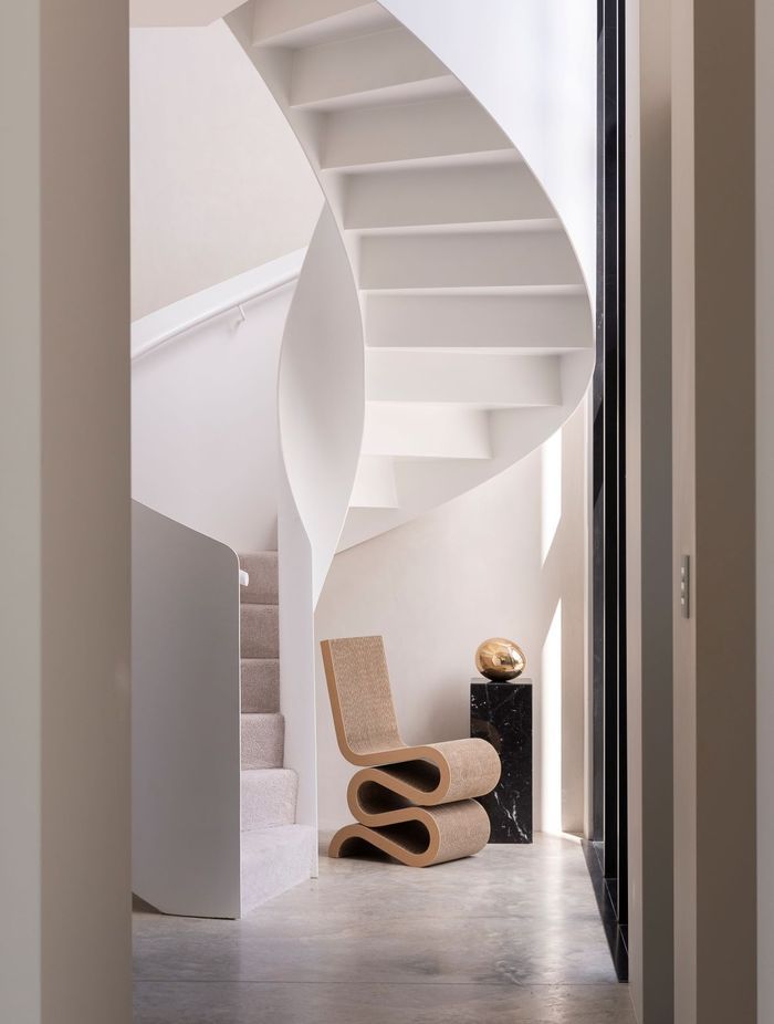 The spiral staircase, made from steel, commands attention in the entrance way.