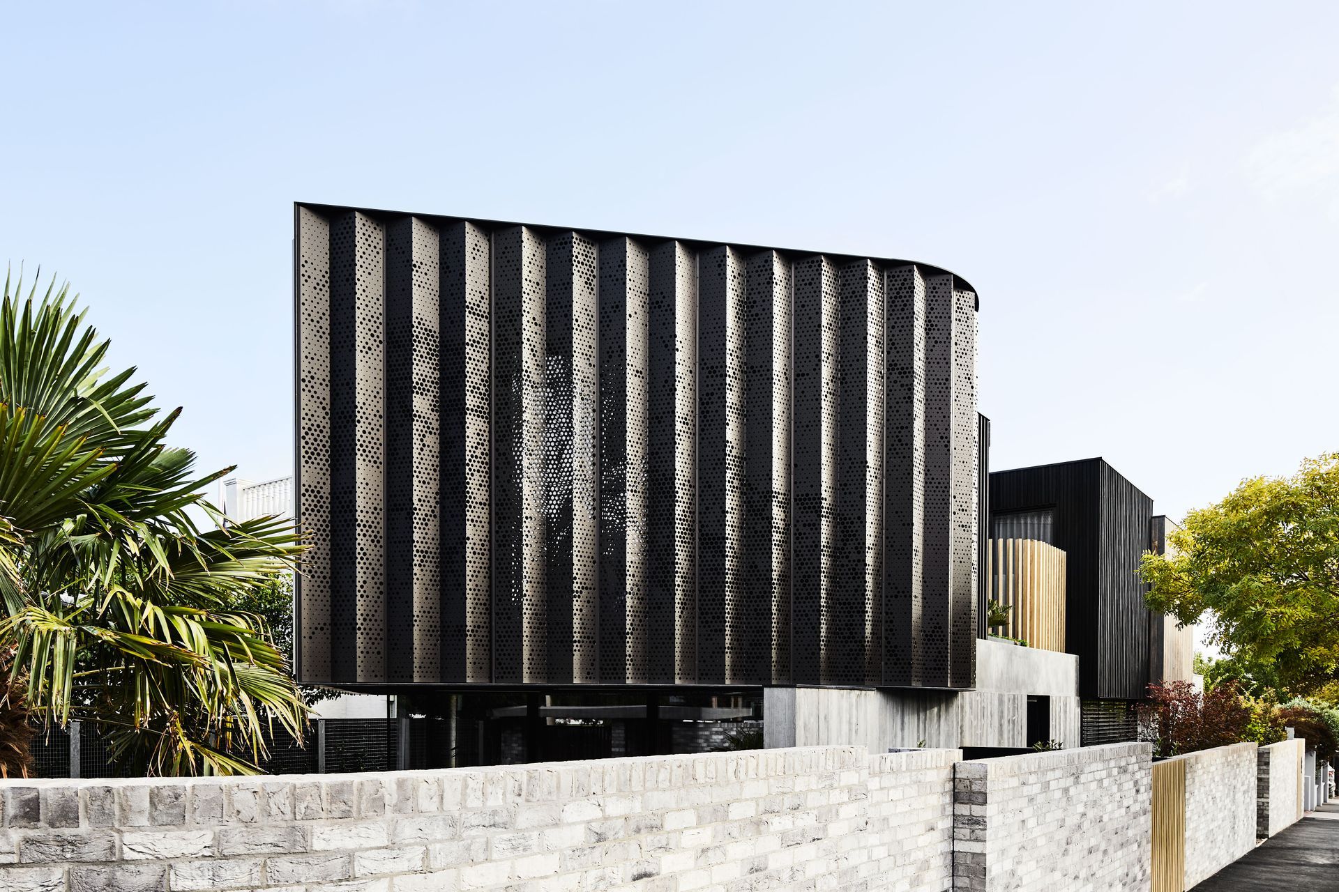 This architectural home stands out with its perforated aluminium cladding.
