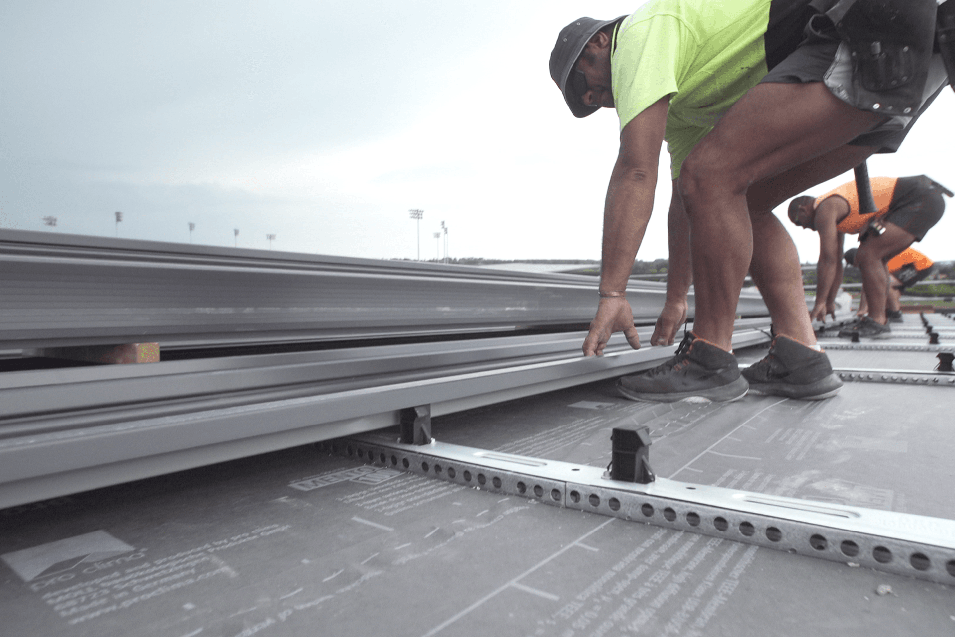 The perforated rail system creates an air space between the roofing sheet and the insulation board.