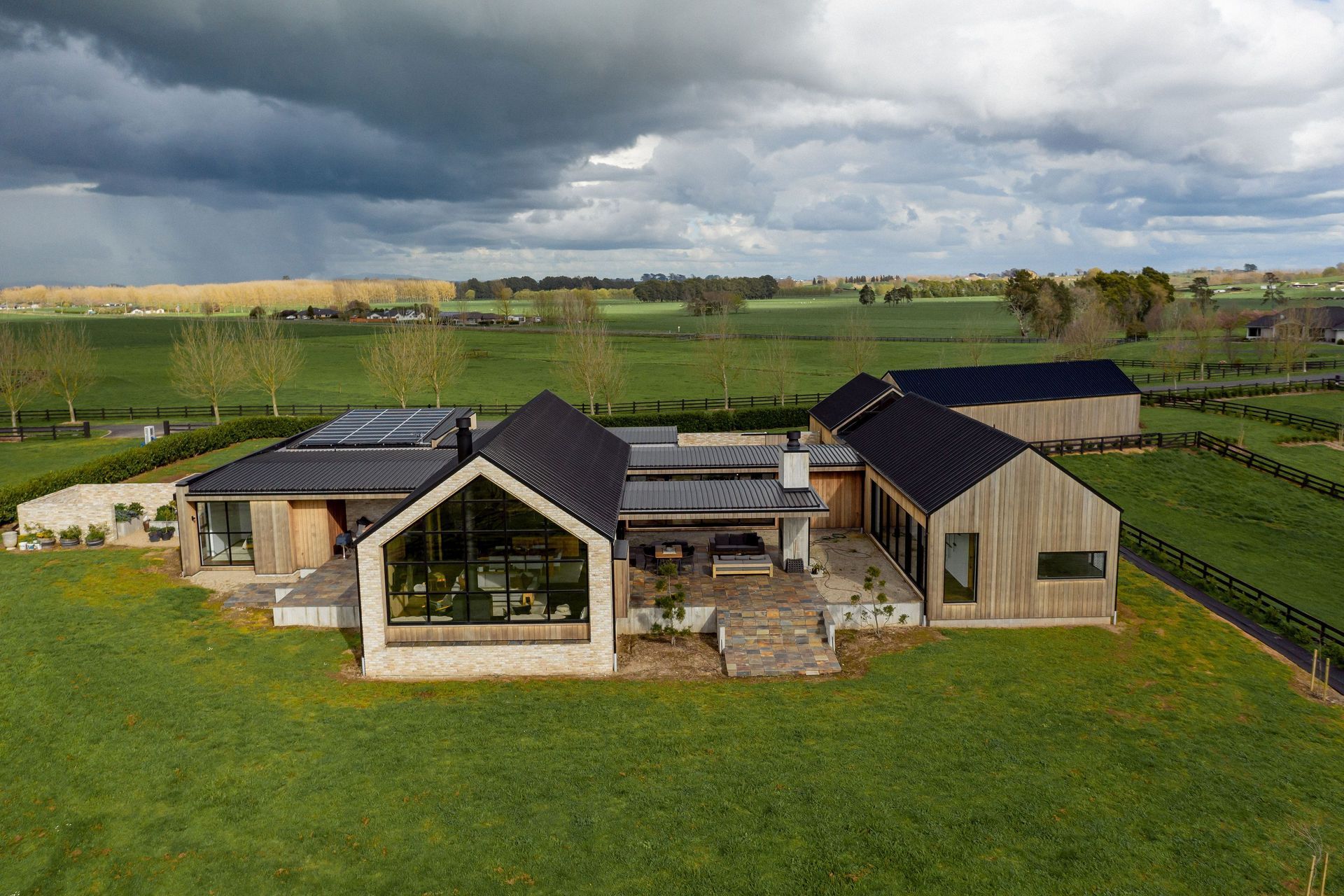 From above, the scattering of gable from buildings interconnected by almost flat pavilion forms echoes a rural architectural vernacular.