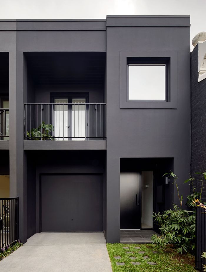 An exquisite black painted exterior, paired with black window frames. Photography by Tatjana Plitt.