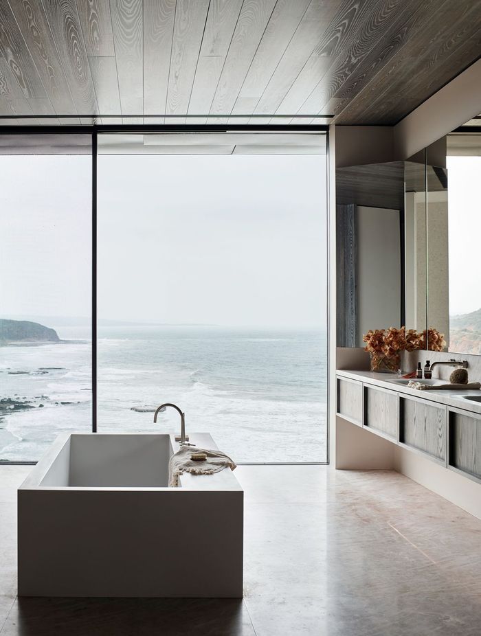 A warm bath can help ease joint pain and promote blood circulation | Great Ocean Road Residence by Rob Mills Architecture &amp; Interiors | Photography by Mark Roper