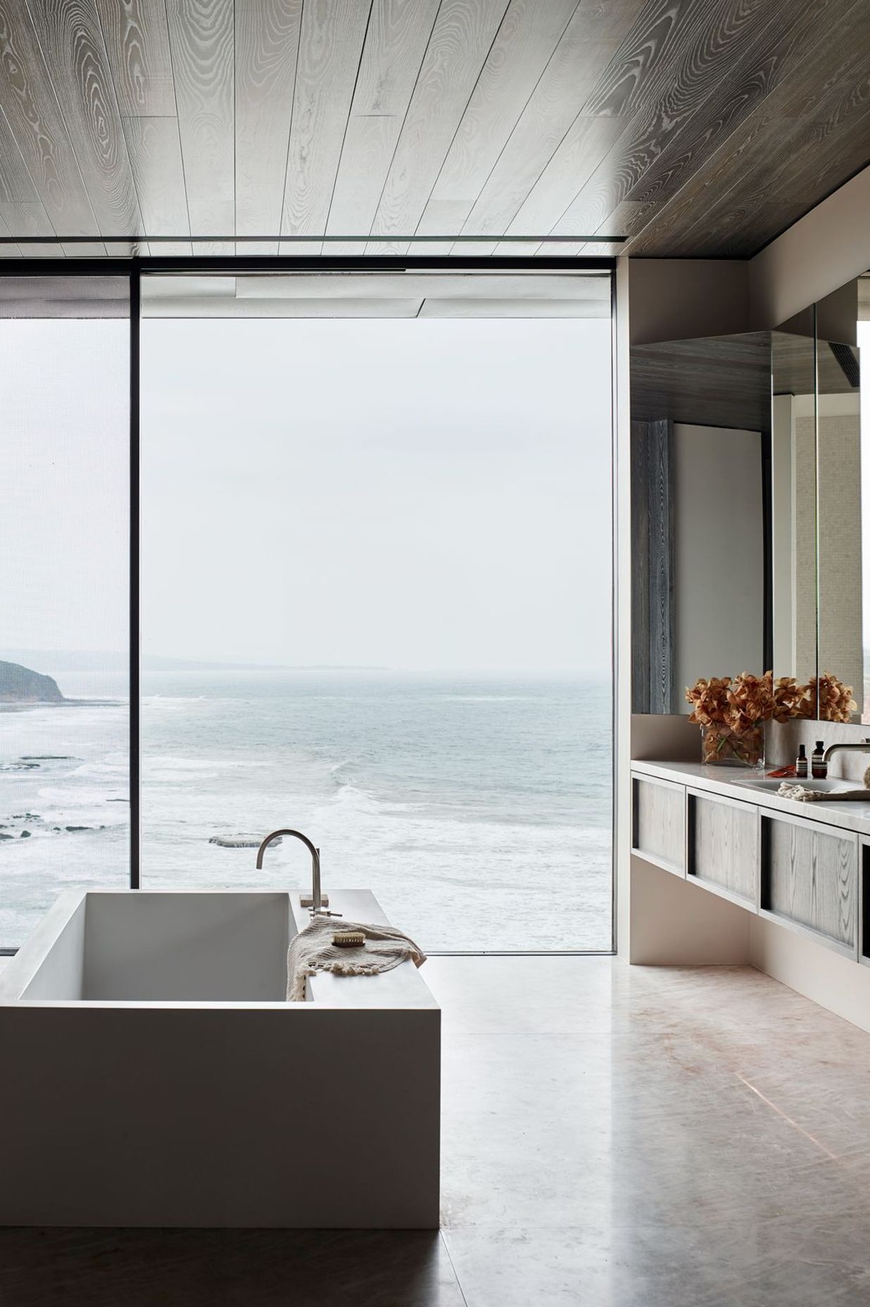 A warm bath can help ease joint pain and promote blood circulation | Great Ocean Road Residence by Rob Mills Architecture &amp; Interiors | Photography by Mark Roper