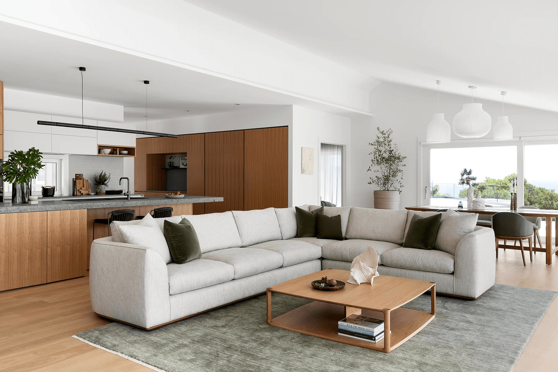 This Erskine Sofa features soft upholstery and a rounded silhouette. Featured here in the Cape Schanck project designed by Rod Hannah Design Group and Cantilever Interiors.