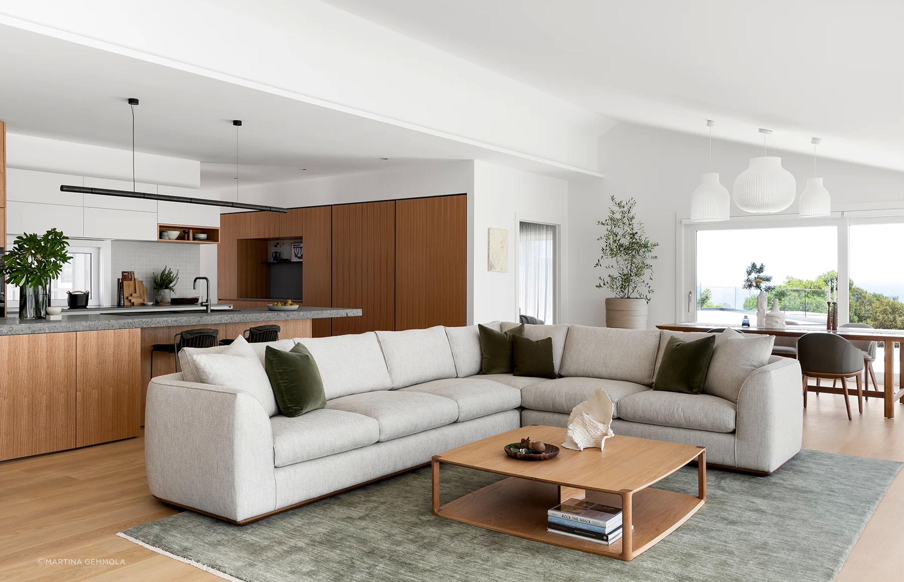 This Erskine Sofa features soft upholstery and a rounded silhouette. Featured here in the Cape Schanck project designed by Rod Hannah Design Group and Cantilever Interiors.