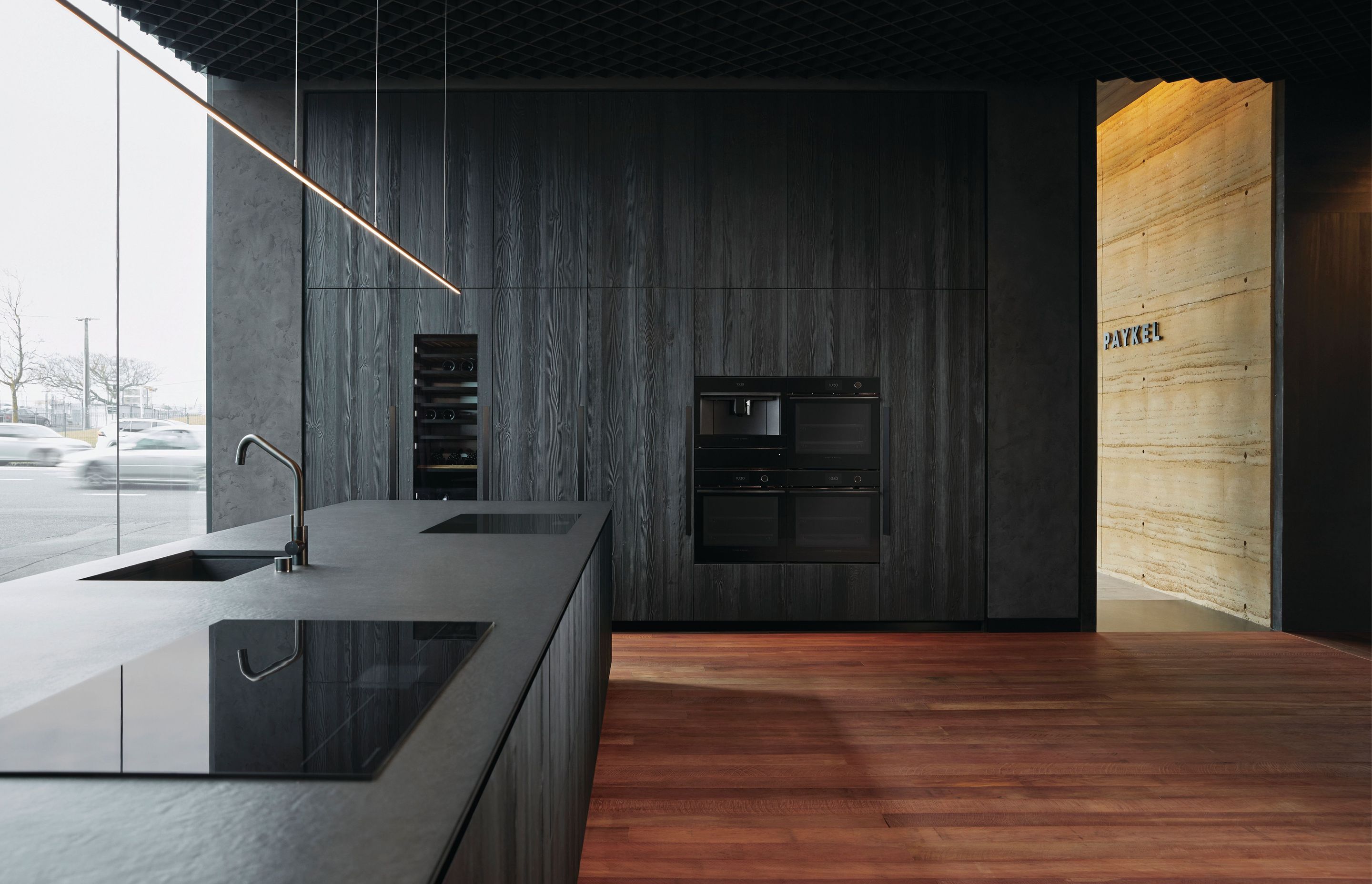 This 'minimal' kitchen features sleek, black appliances to match the paired back aesthetic.