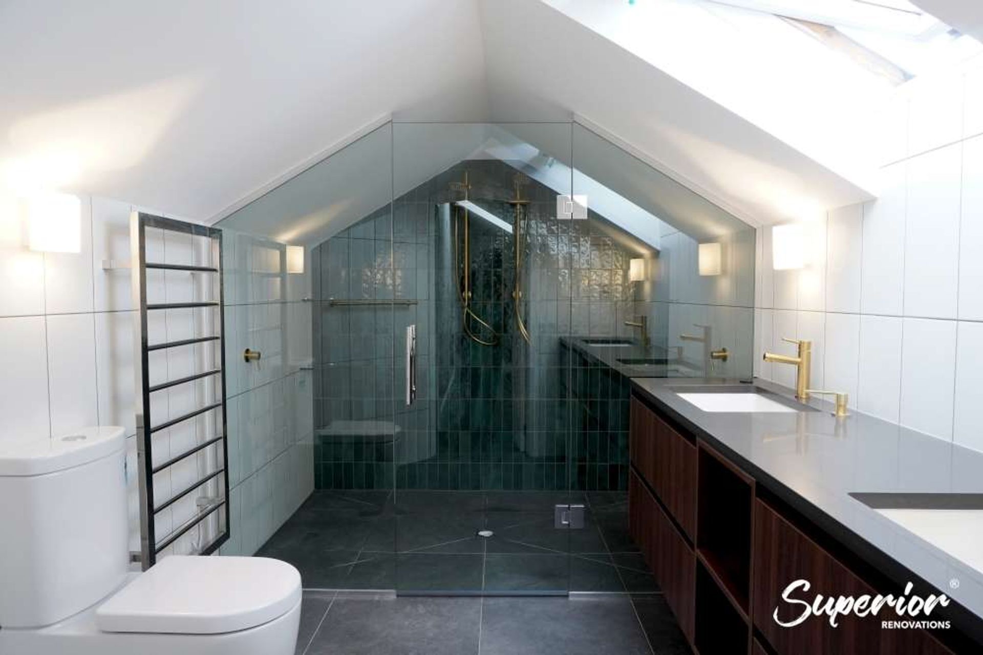 Spacious shower integrated in this bathroom design for a renovation in Westmere