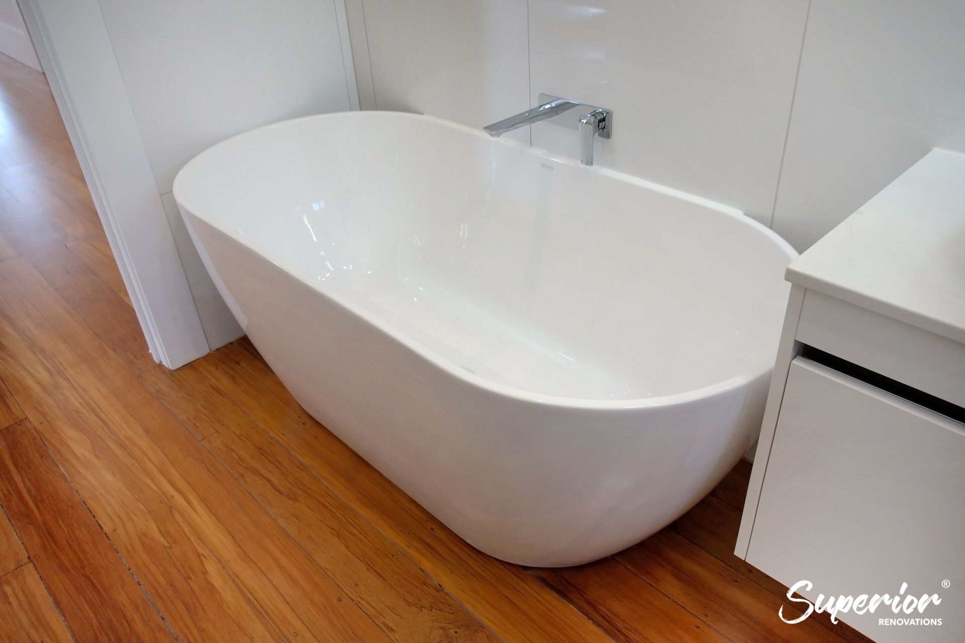 Oval shaped bath in Epsom which saves space