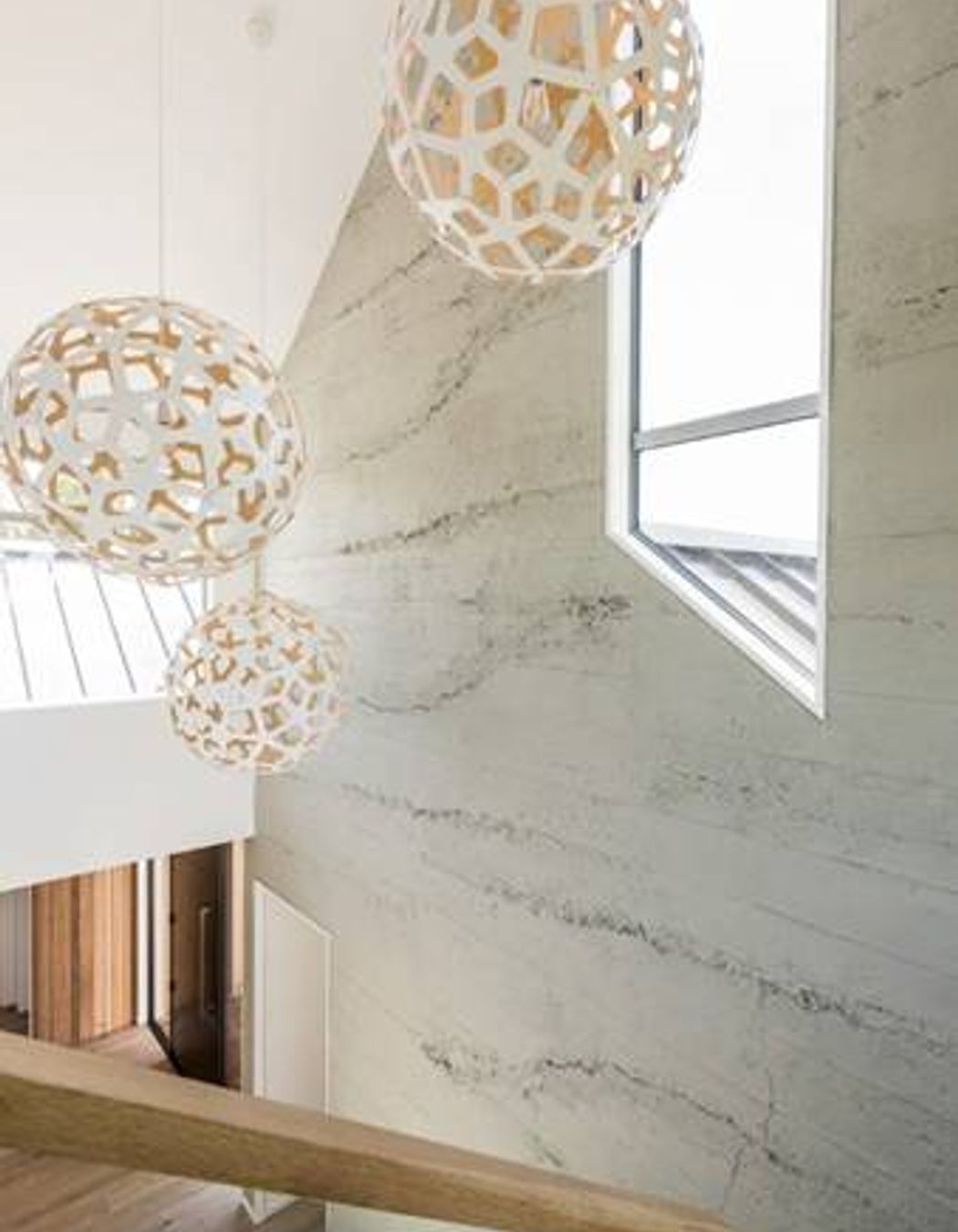 Roughcast concrete wall panels by Muros showcase the subtle rawness of concrete.