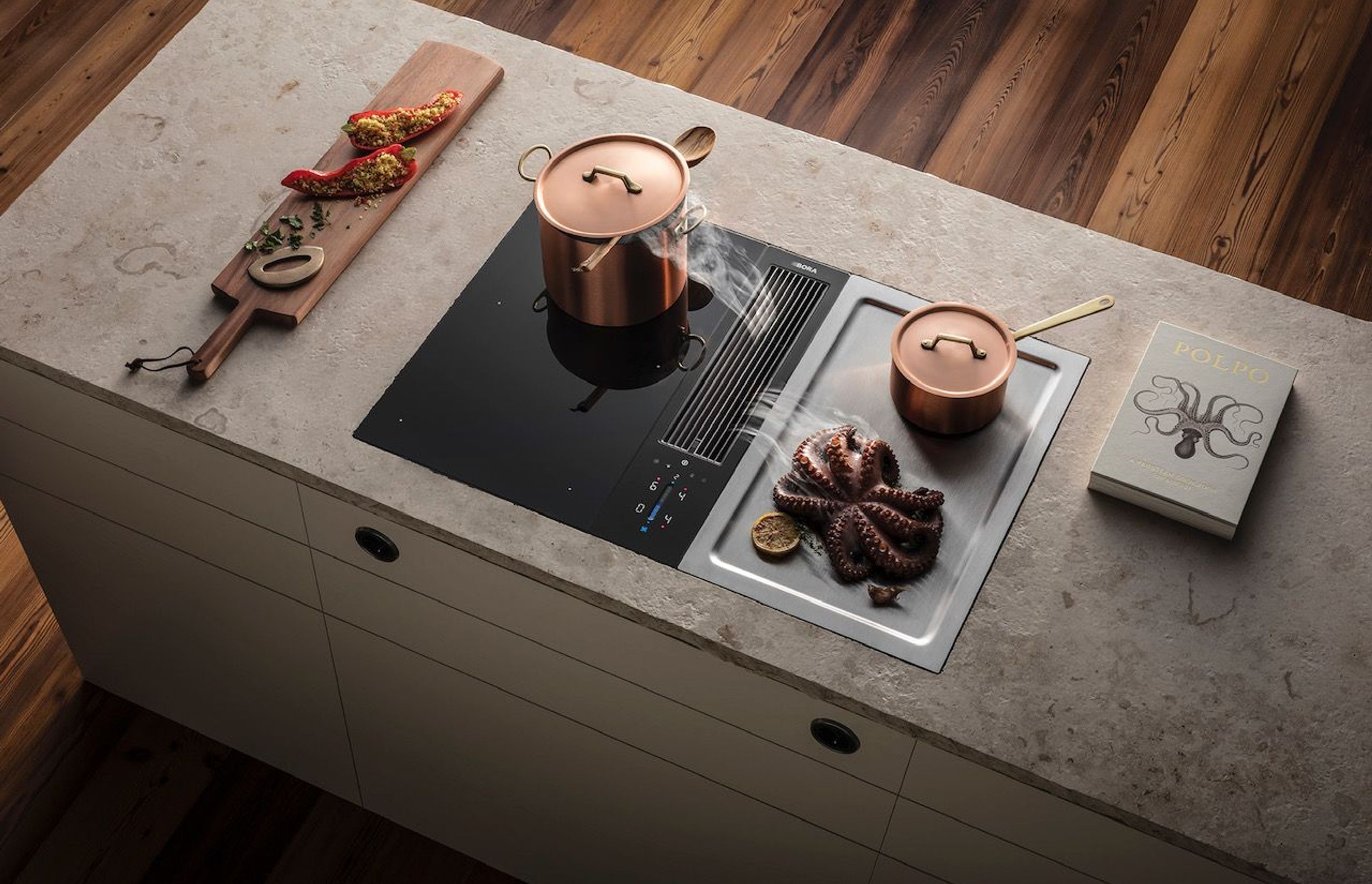 The BORA Classic 2.0 is a modular cooktop and extractor system designed to be seamlessly integrated into island benches.