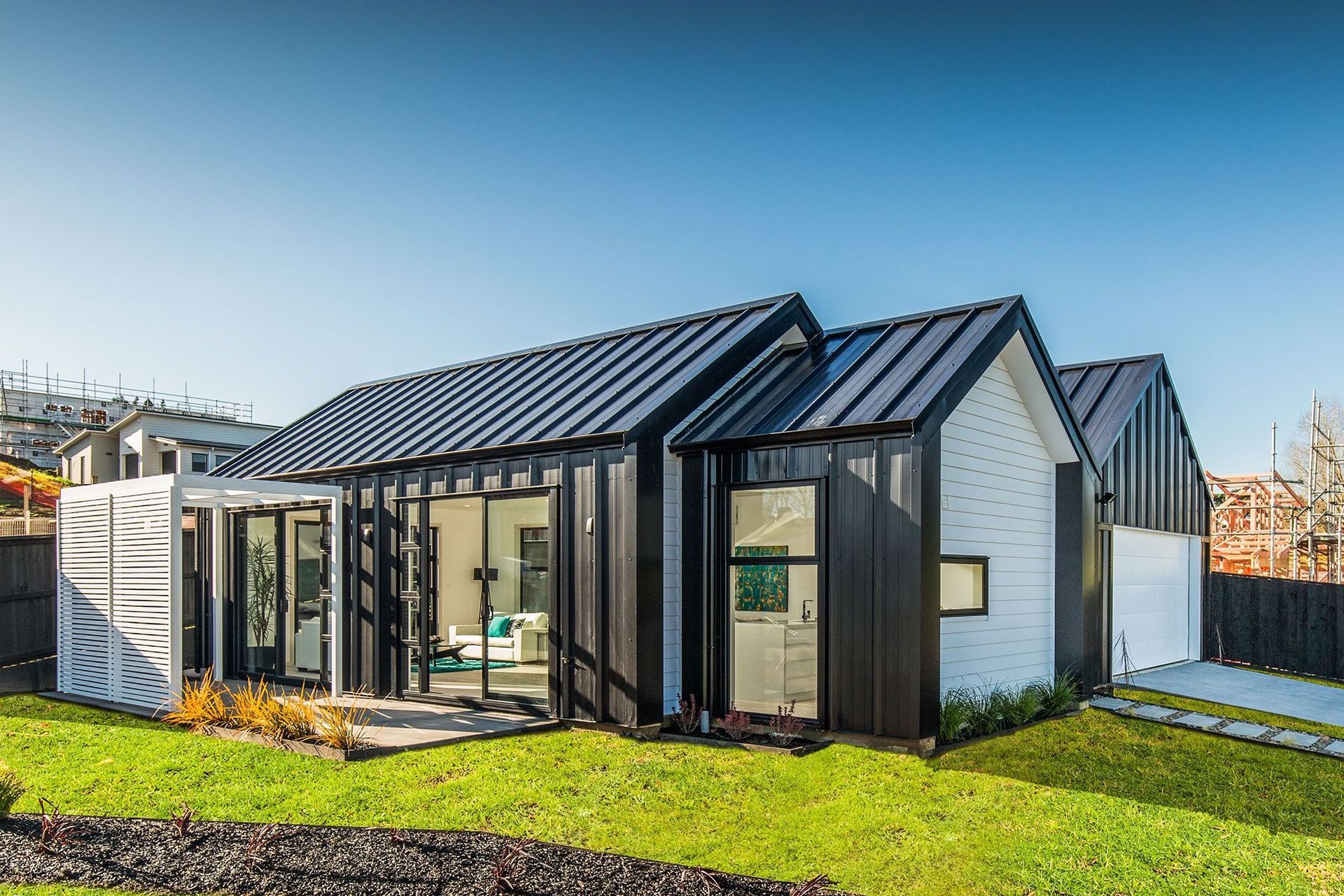The contrast of black Solar-Rib cladding and white is a simple yet powerful design.