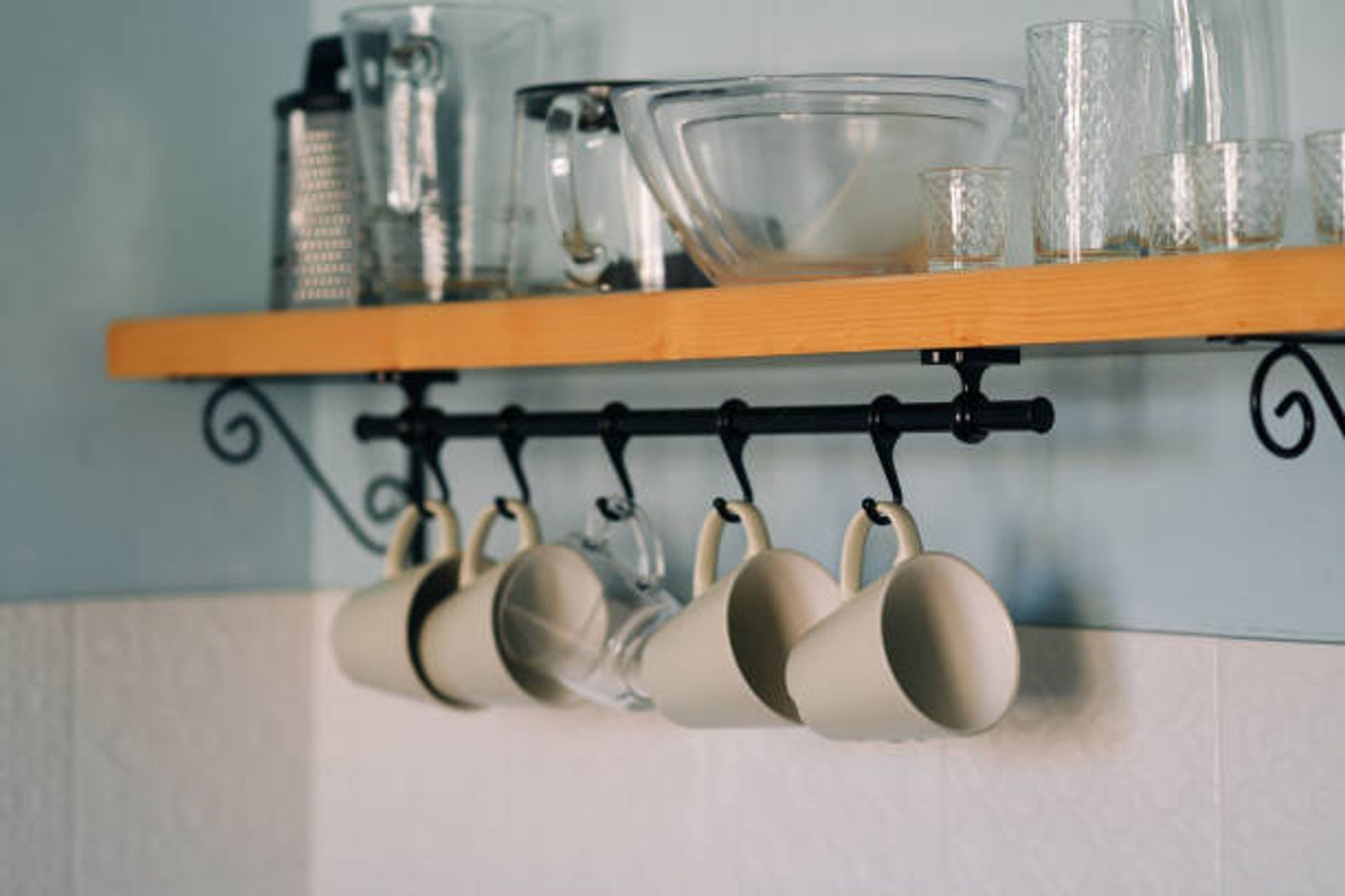 Cup hooks underneath a shelf | Photo Credit – iStock