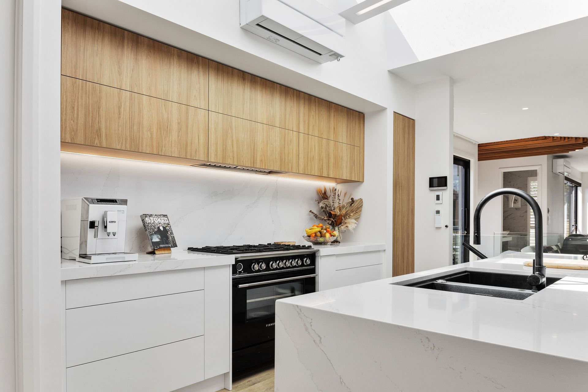 The kitchen is flooded with natural light from the skylights overhead.