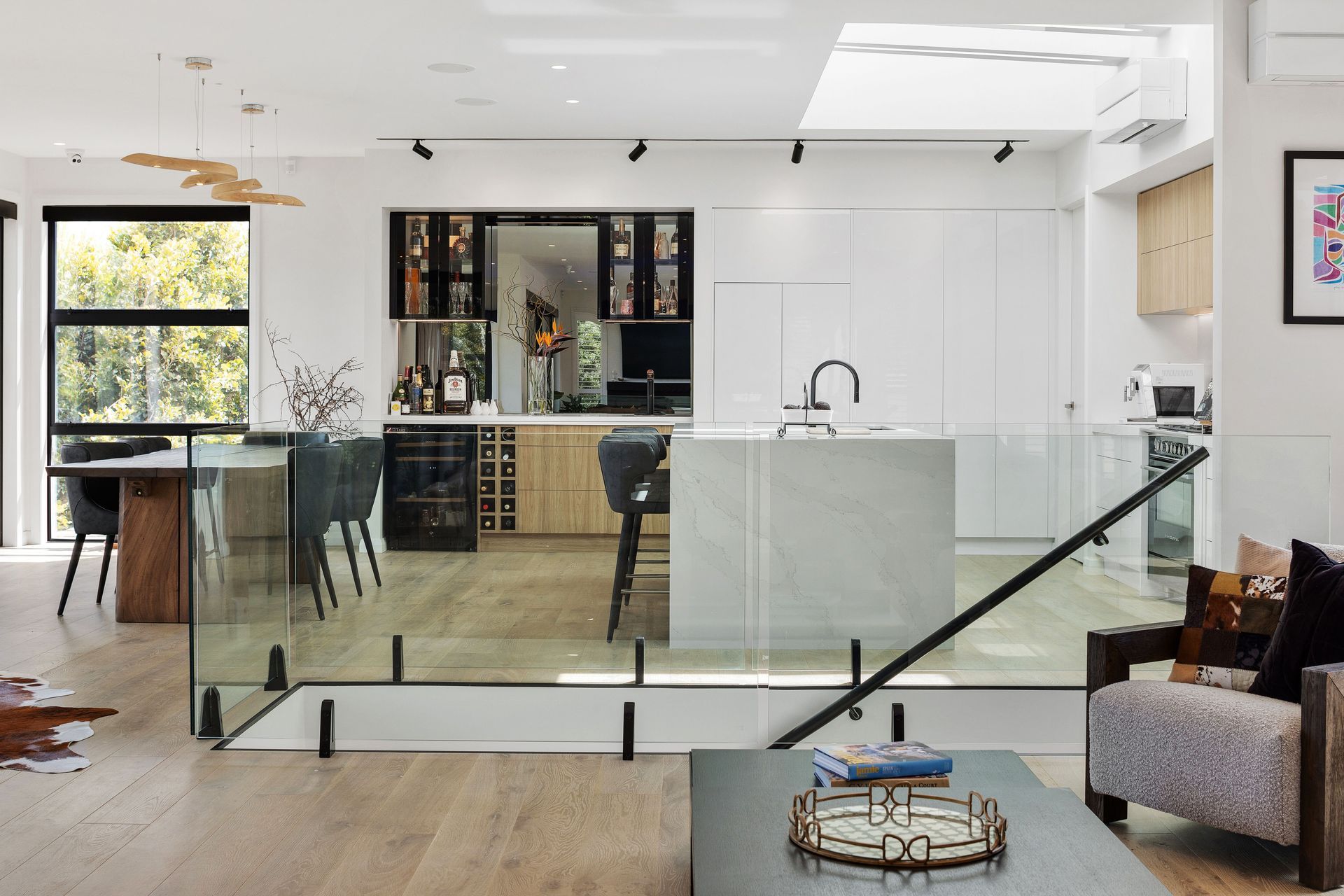 The open-plan kitchen and dining area features a mirrored bar.