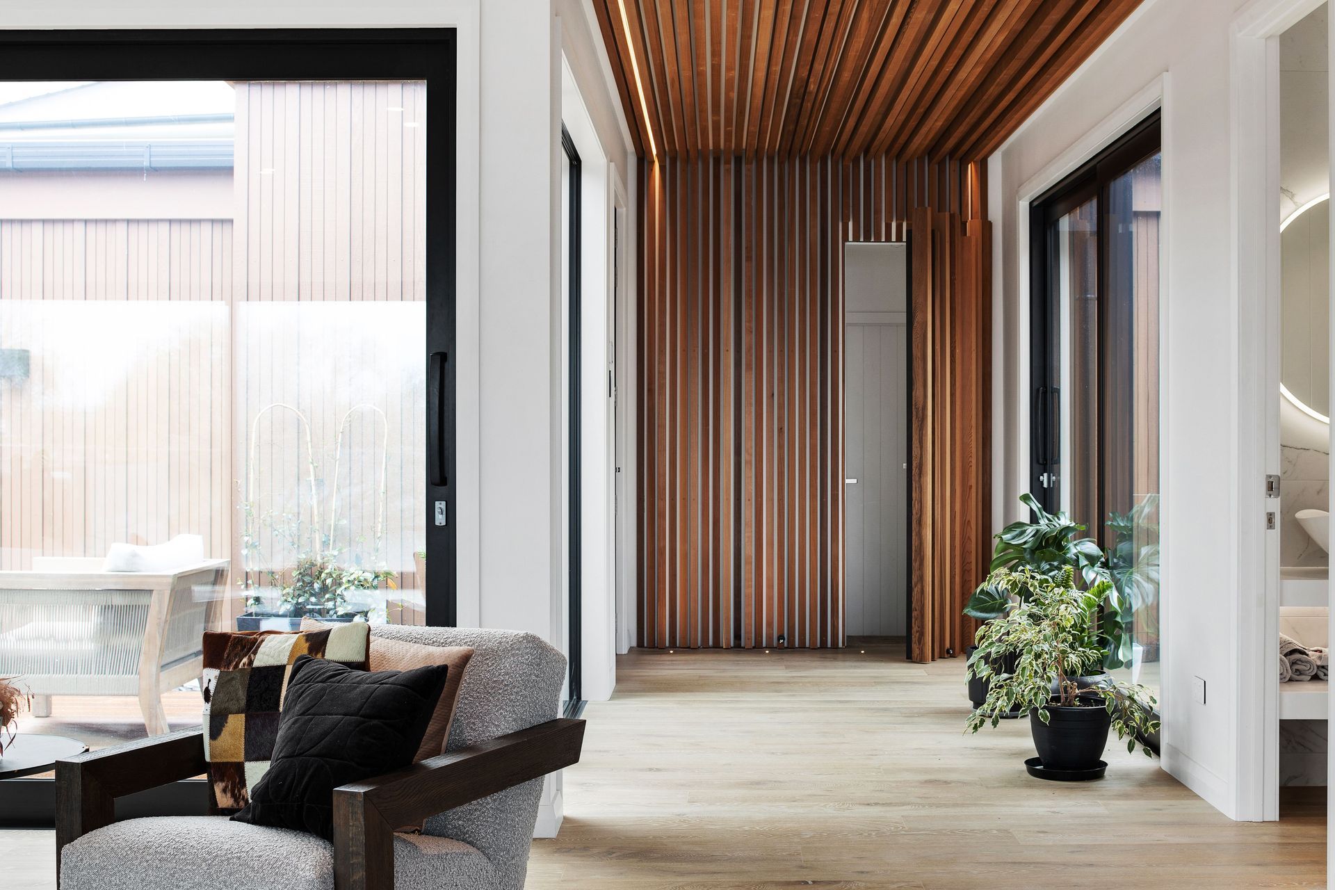 The cedar 'waterfall' artfully conceals the door to the bedrooms.