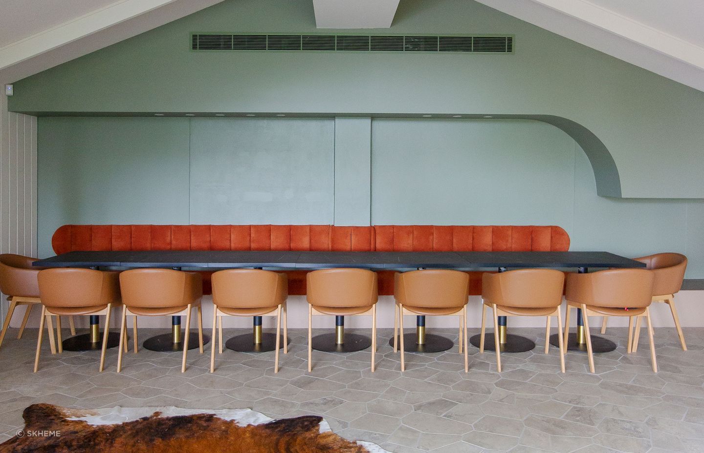 A spacious dining room featuring large-format floor tiles designed with fewer grout lines, creating a seamless and visually expansive surface