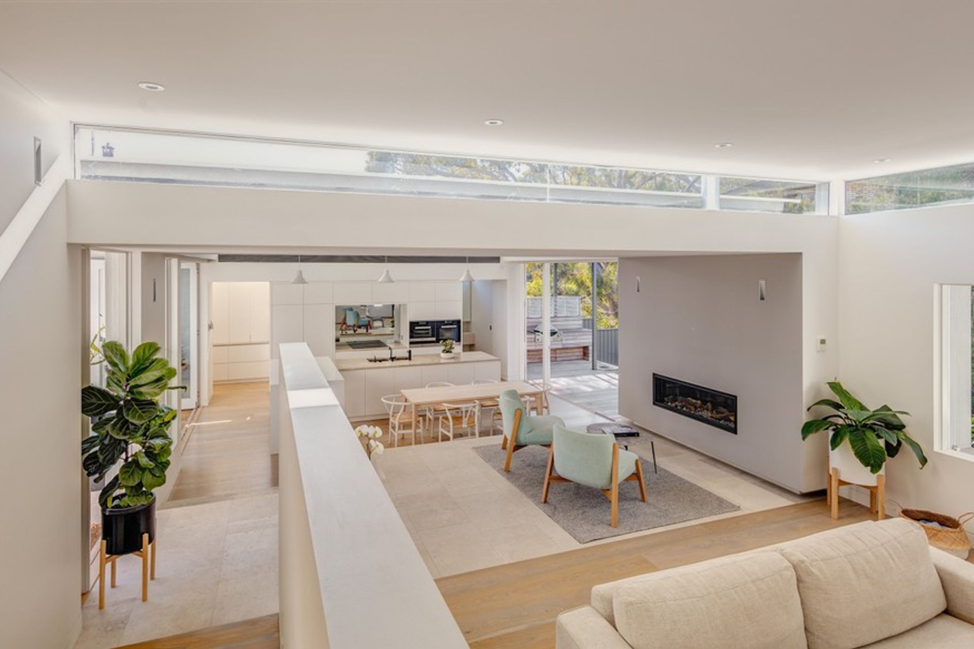Subtle level changes and variations in light work to define the zones of living while maintaining an open plan layout.