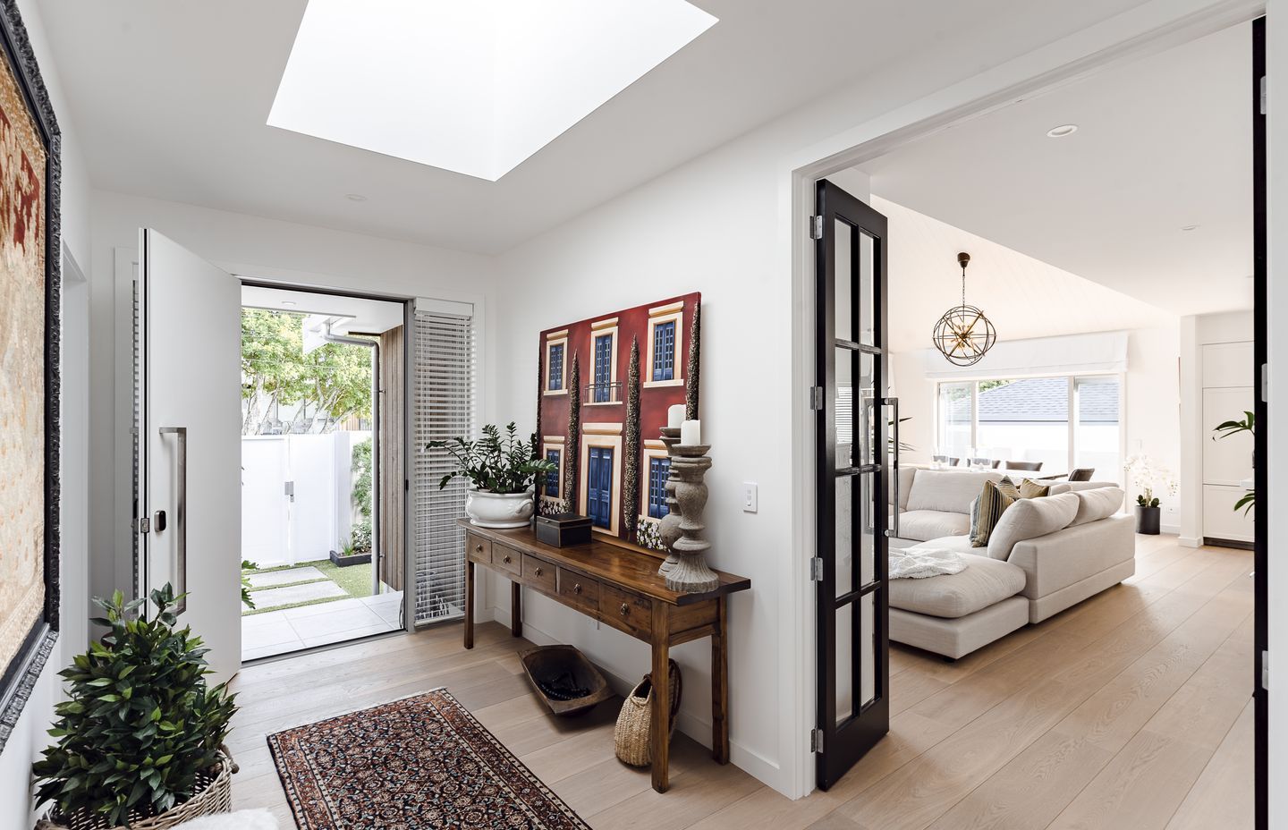 The entryway bridges the two gable-roofed wings.