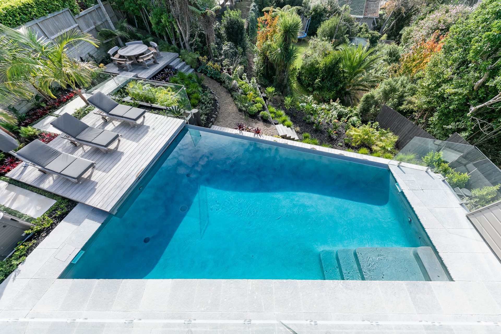 The swimming pool, constructed by Auckland Inground Pools, was the centrepiece of the landscaping project.