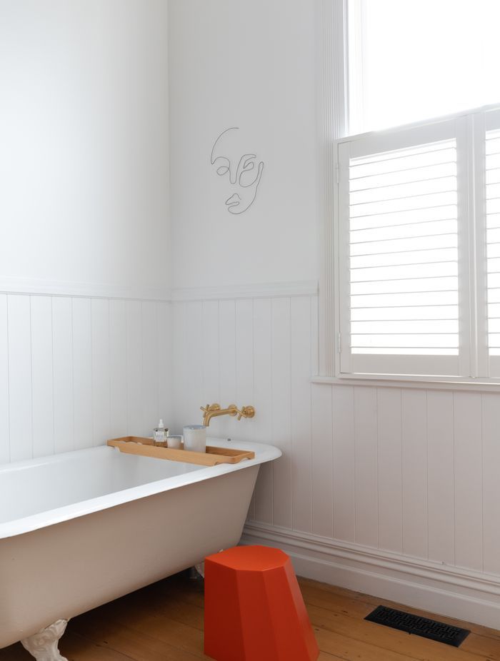 An Arnoldino stool in orange adds a pop of colour.