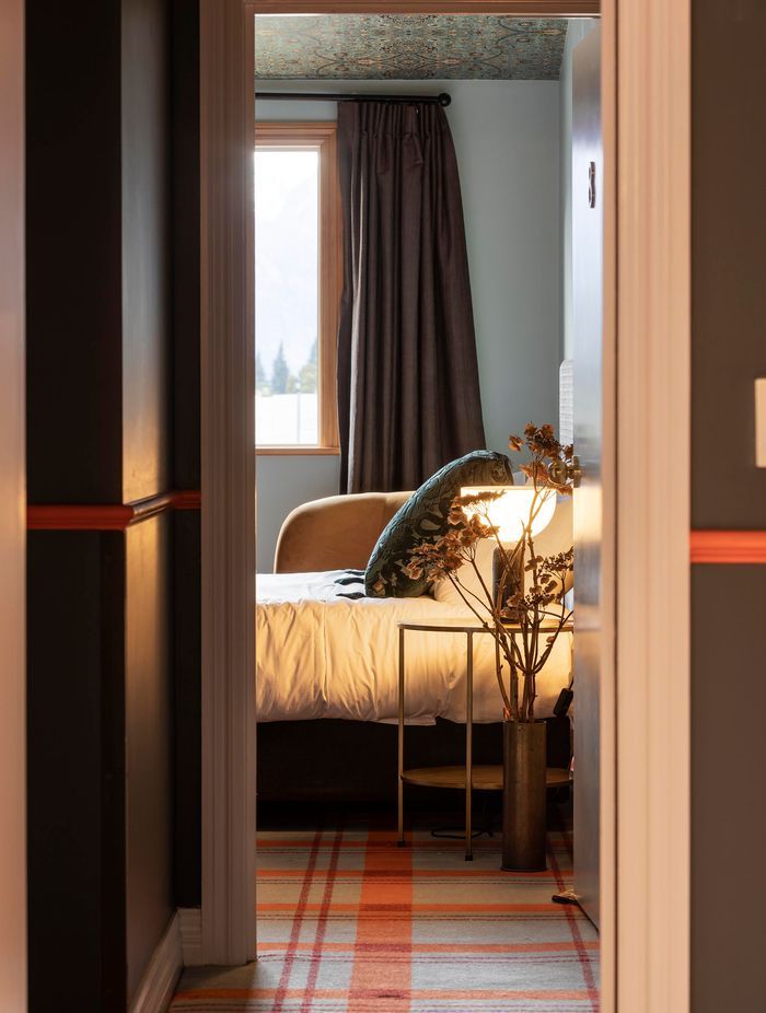 Blue and orange tartan carpet was chosen for this project. "Once we nailed this carpet choice and everyone was happy with it, everything flowed from there," says Liv.