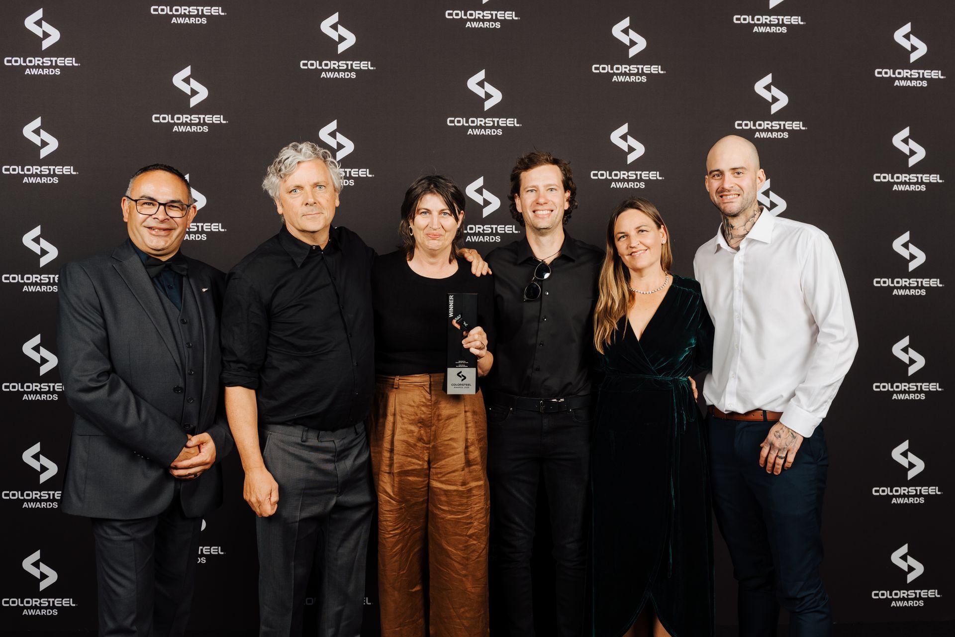 Kerr Ritchie Architects accepts the award for Residential Building of the Year with the Velvin Building team.