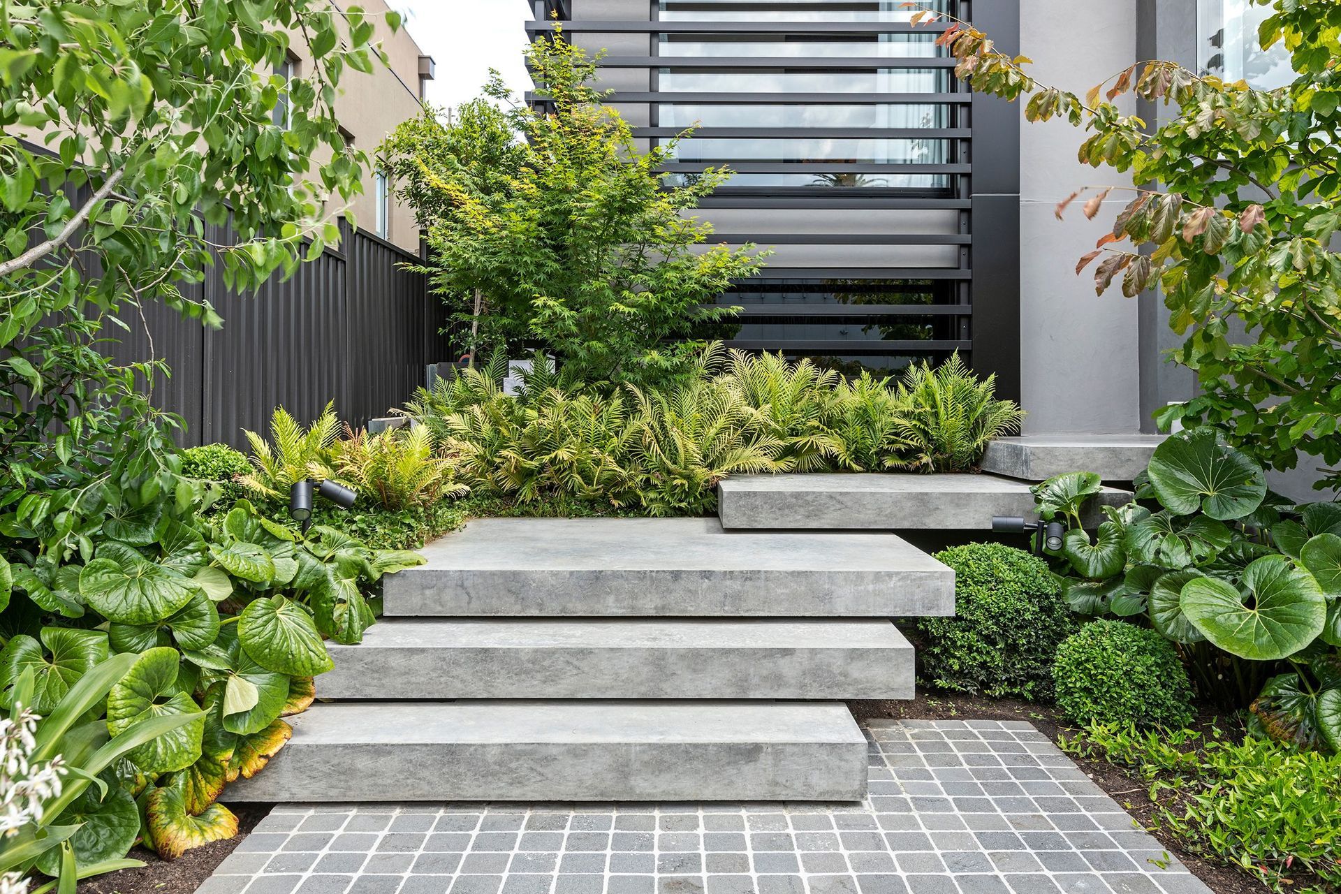 Designed for beauty and durability, Holcim's new decorative concrete range, featuring 12 contemporary colours, provides a high-quality appearance and a practical alternative to paving, asphalt, marble, or timber. Image: Geostone Project at Antares Court.