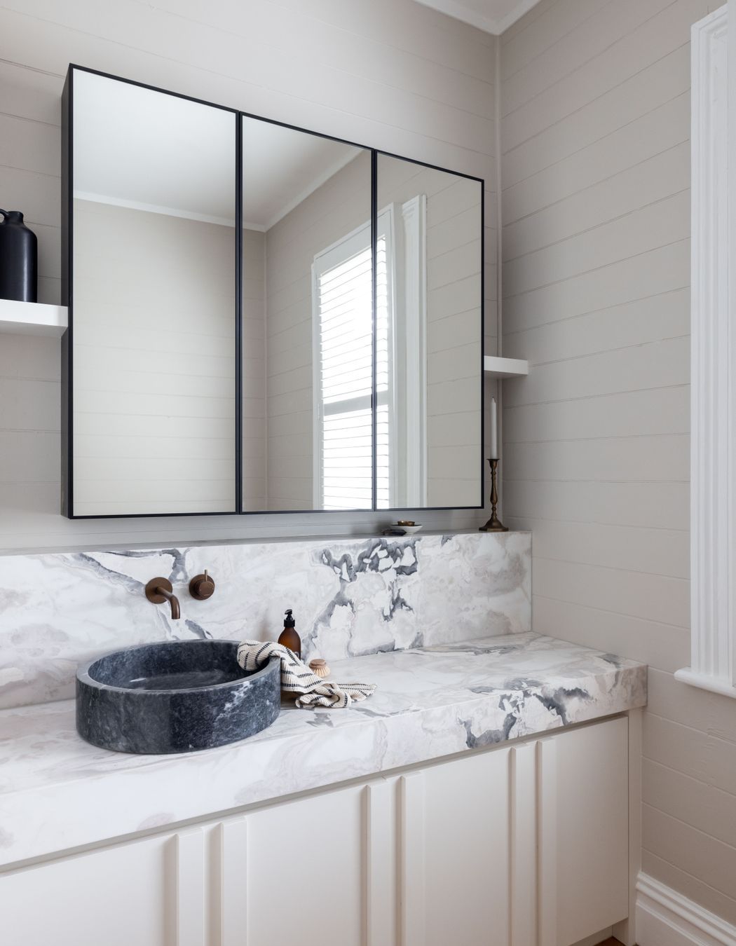The original shiplap has been retained in the bathroom to honour the home's heritage.
