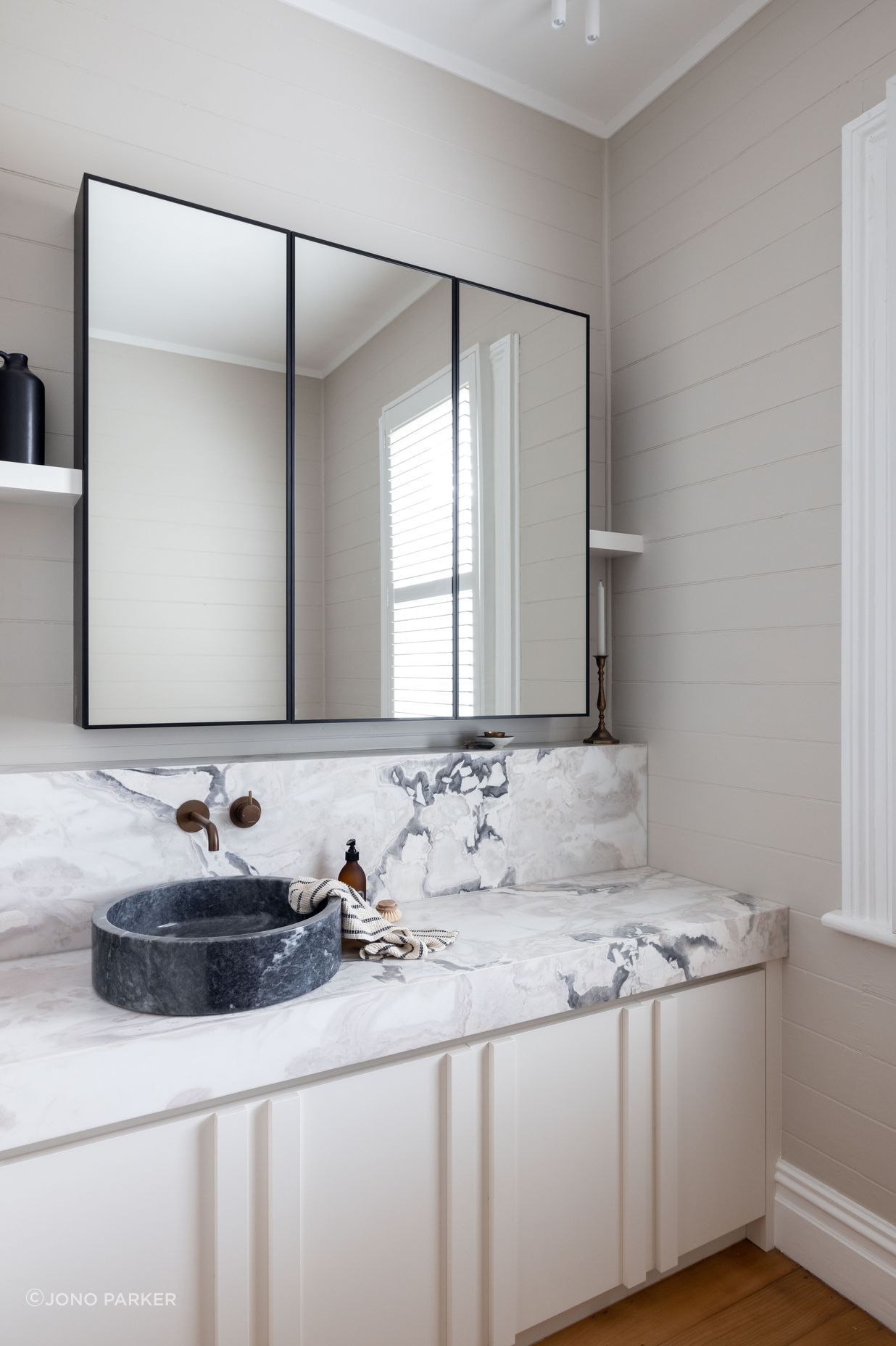 The original shiplap has been retained in the bathroom to honour the home's heritage.