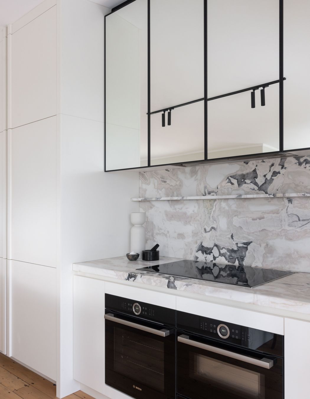 Sections of mirror reflect light and make the space feel larger.