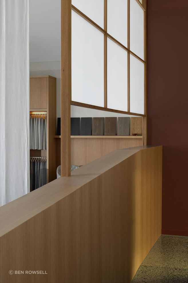 Within Acorn Showroom, a layered entry sequence defined by shoji-inspired screening and warm timber joinery gently guides movement while framing moments of pause.