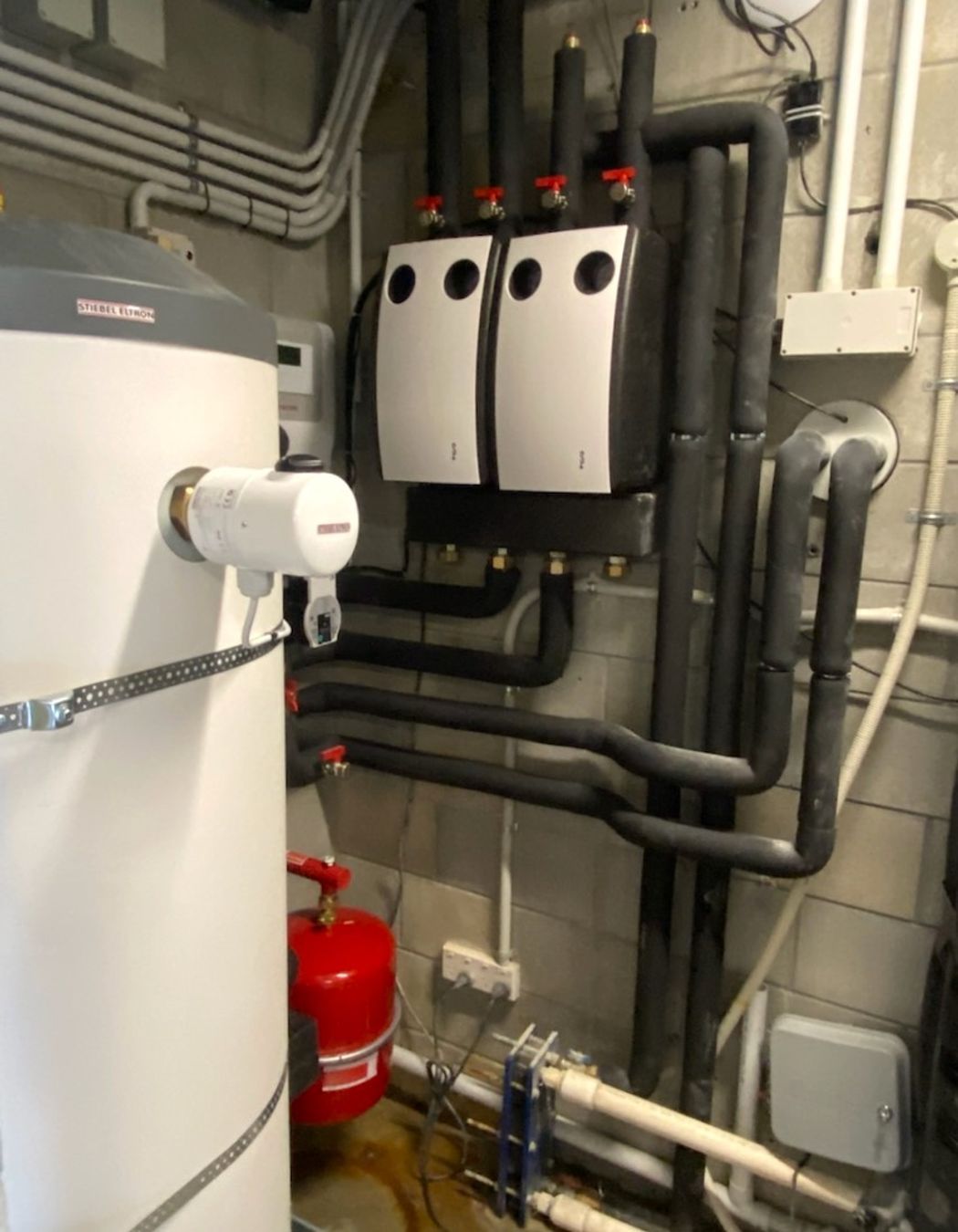 The new plant room set-up replacing the gas boiler with a heating circuit pump station and potable water cylinder.