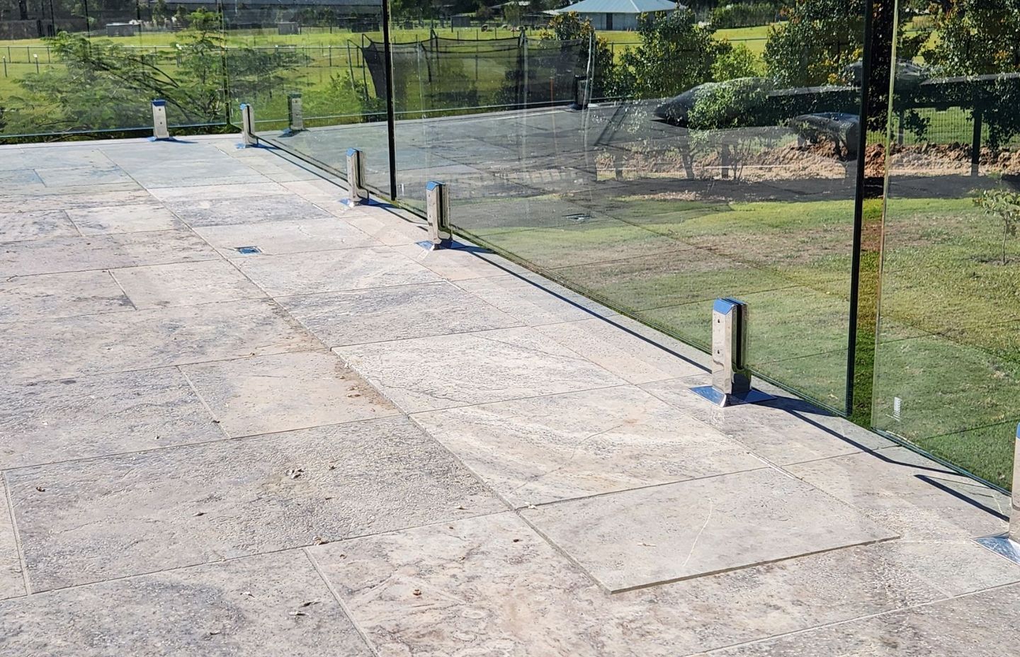 Here, the tiles are in-laid so that the surface of the pool cover lid is flush with the surface of the pool surround.