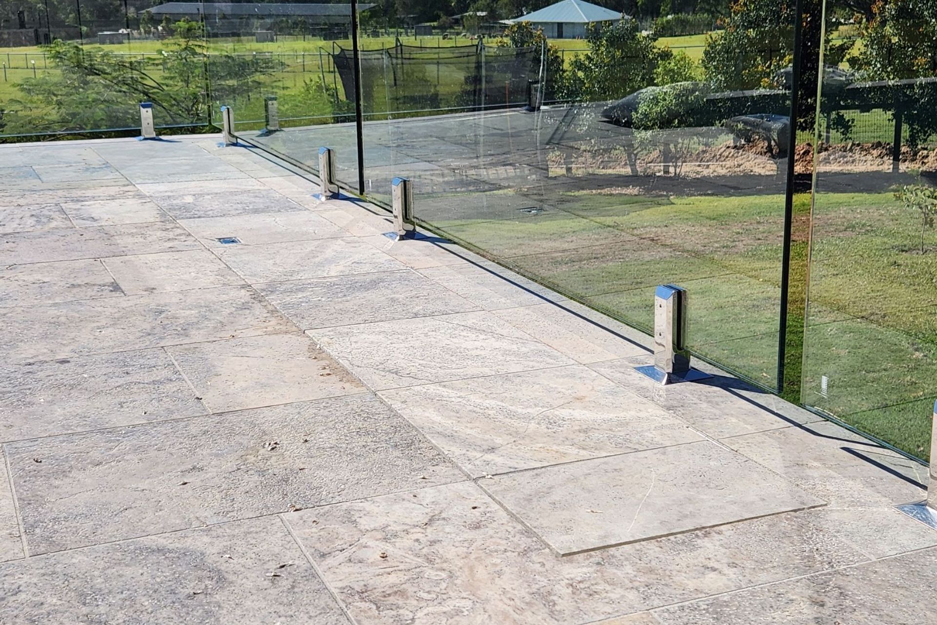 Here, the tiles are in-laid so that the surface of the pool cover lid is flush with the surface of the pool surround.