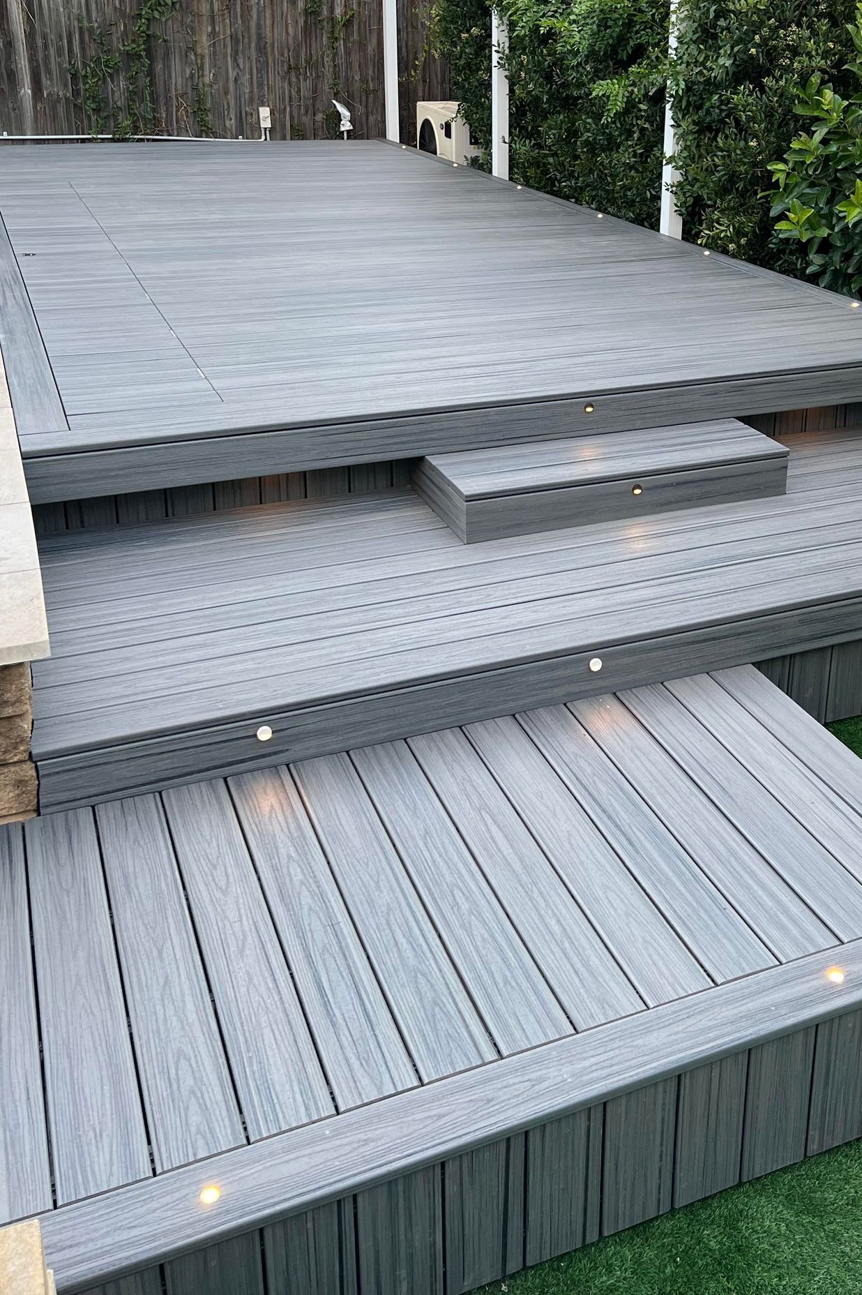 This composite timber deck shows the timber in-laid into the pool cover so that it's virtually invisible.