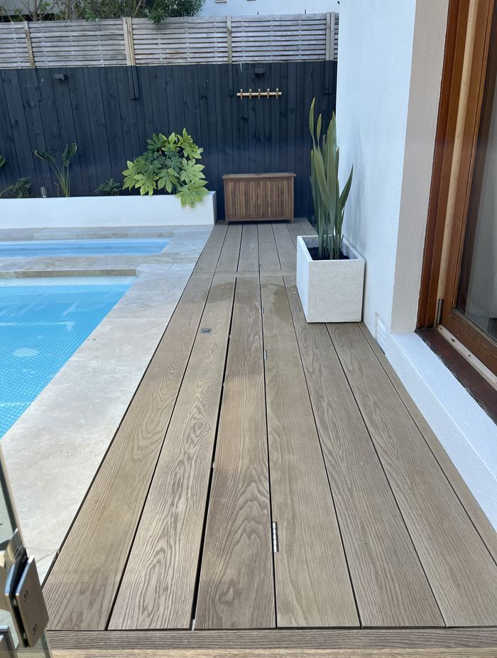 This timber decking pool cover is so seamless, it's practically invisible.
