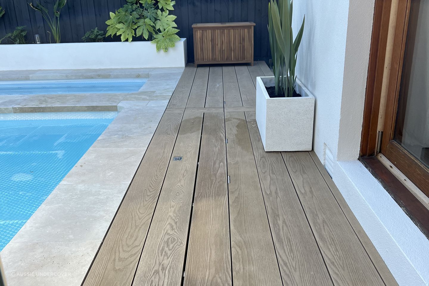 This timber decking pool cover is so seamless, it's practically invisible.