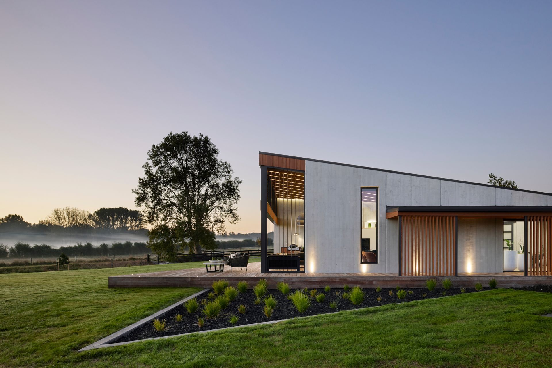 The exterior provides a glimpse as to what to expect inside: natural tones and textures and a soaring ceiling in the living pavilion.